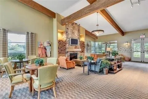 a living room with fireplace furniture and a large window