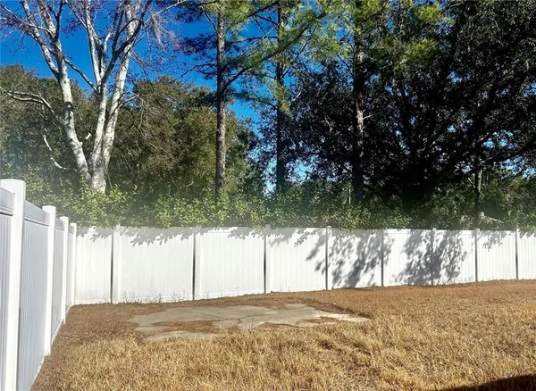 a view of a yard with a tree