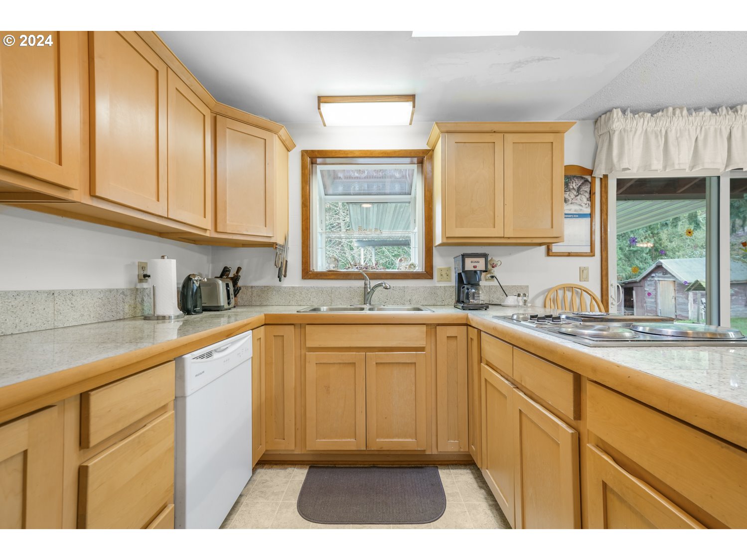 29015 Southeast Church Road Boring, OR 97009 - Photo 12 of 41 a kitchen with granite countertop a sink stainless steel appliances and cabinets