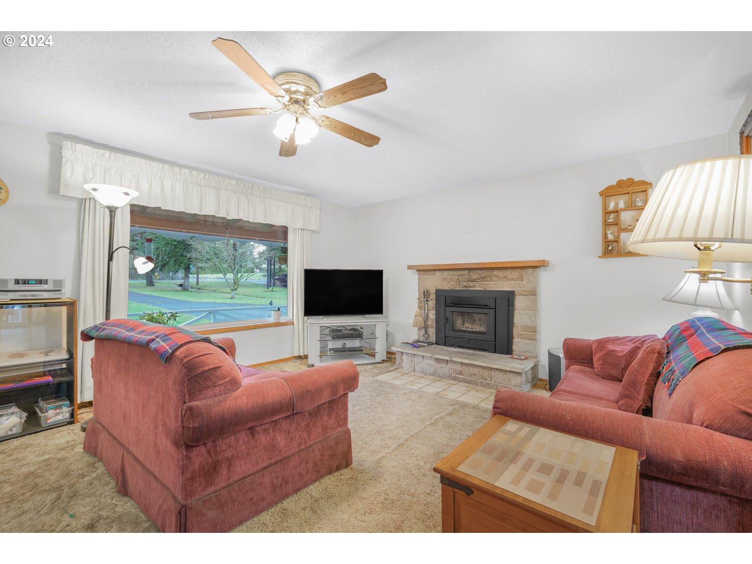 29015 Southeast Church Road Boring, OR 97009 - Photo 10 of 41 a living room with furniture a flat screen tv and a fireplace