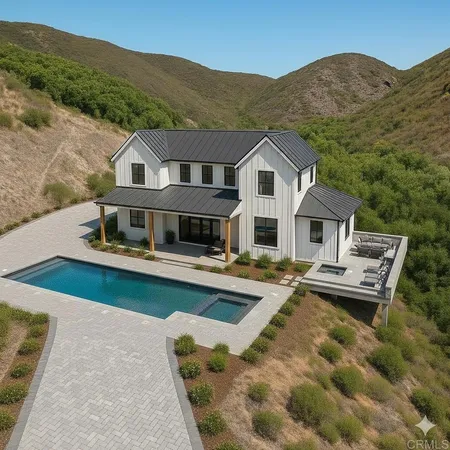 a aerial view of a house with swimming pool table and chairs