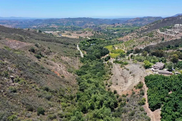 an aerial view of a houses with a yard