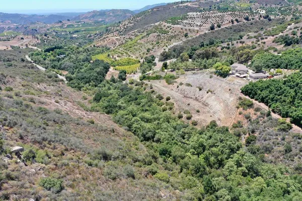 an aerial view of a houses with a yard