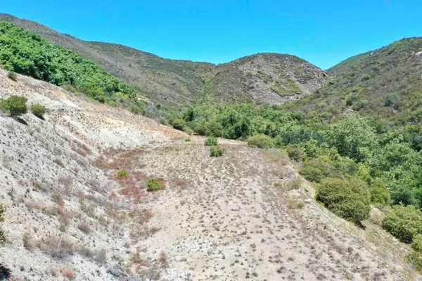 a view of a large mountain with a mountain in the background