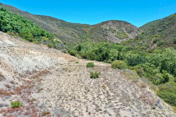 a view of a mountain with a mountain in the background