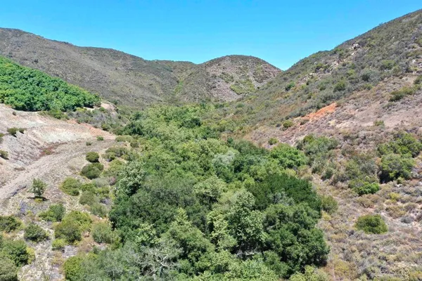 a view of a large mountain with a mountain in the background