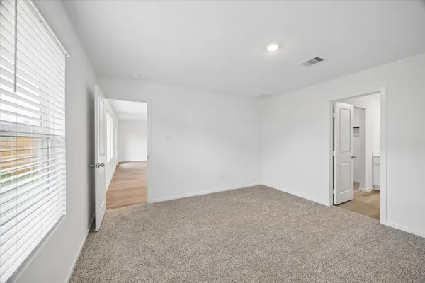 a view of an empty room and a window