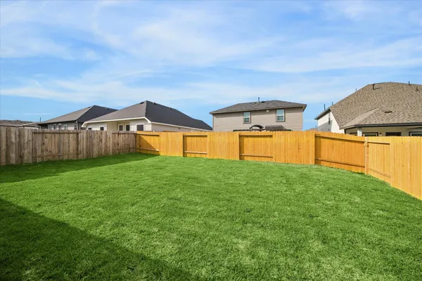 a backyard of a house with table and chairs