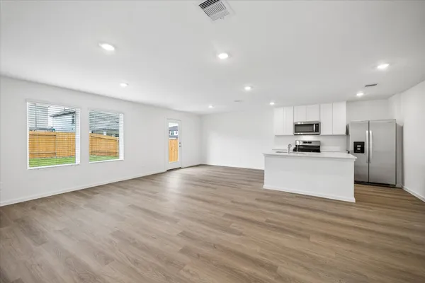 a view of kitchen with microwave and refrigerator