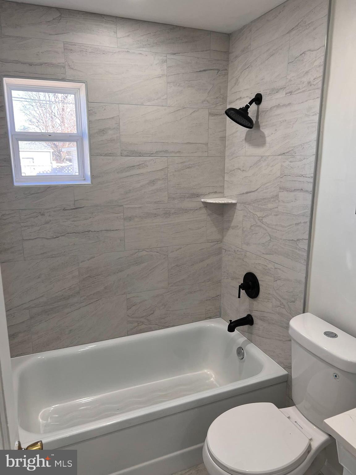 1325 Fuselage Avenue Baltimore, MD 21220 - Photo 7 of 10 a bathroom with a toilet and a bath tub