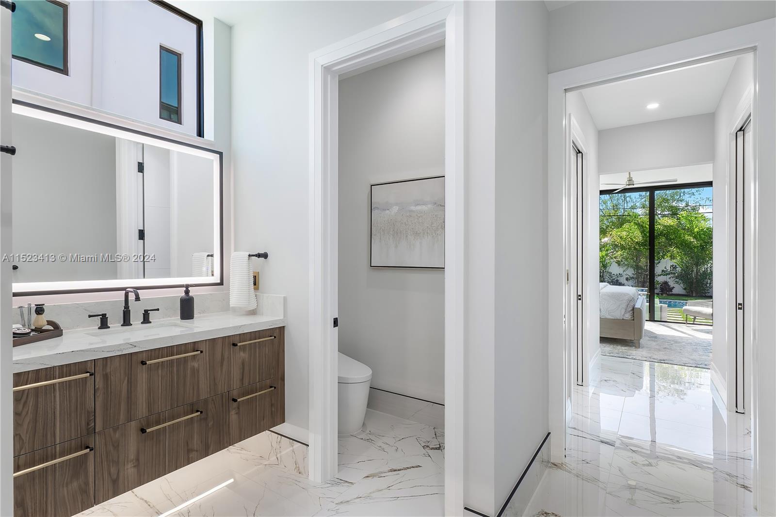 364 Northeast 6th Street Boca Raton, FL 33432 - Photo 28 of 80 a bathroom with a double vanity sink and a mirror