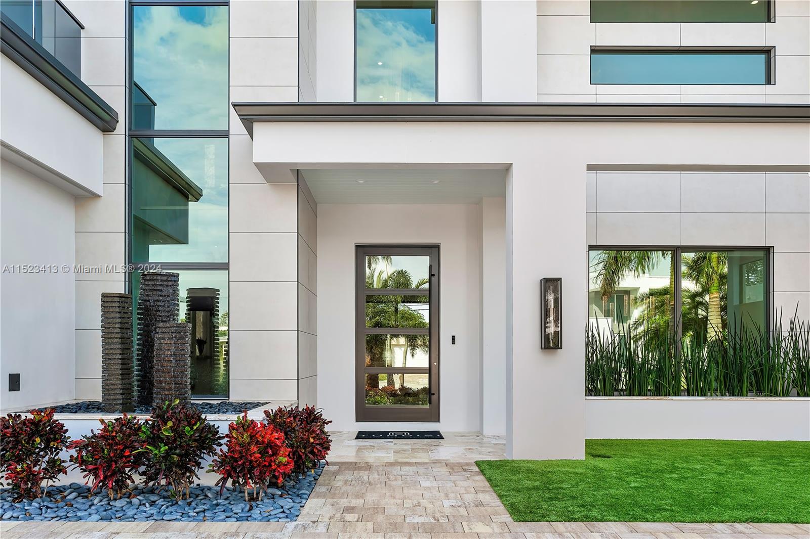 364 Northeast 6th Street Boca Raton, FL 33432 - Photo 8 of 80 a front view of a house with a garden