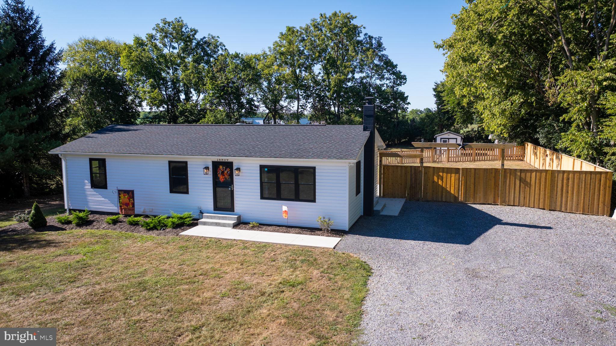 16809 Broadfording Road Hagerstown, MD 21740 - Photo 6 of 49 a front view of a house with a yard and trees