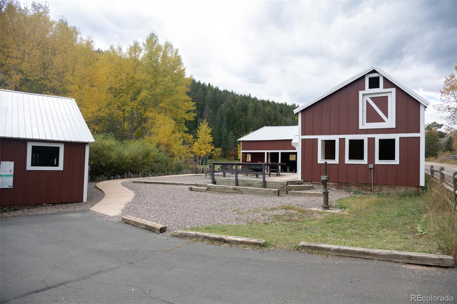 8077 Drew Hill Road Golden, CO 80403 - Photo 47 of 50 a front view of a house with a yard and garage
