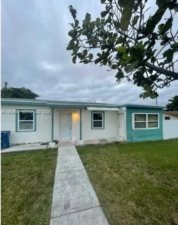 a front view of house with yard and trees