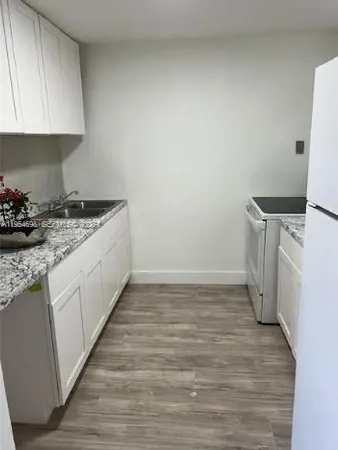 a kitchen with a stove and a refrigerator