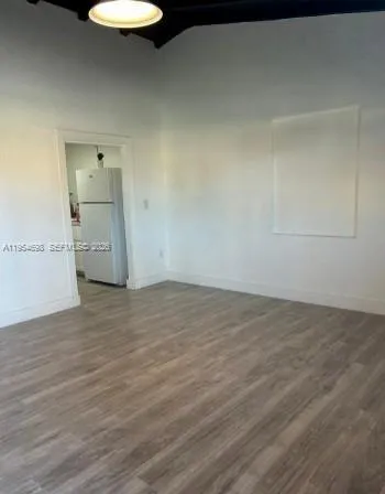 a view of a room with wooden floor