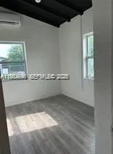 a view of wooden floor and windows in a room