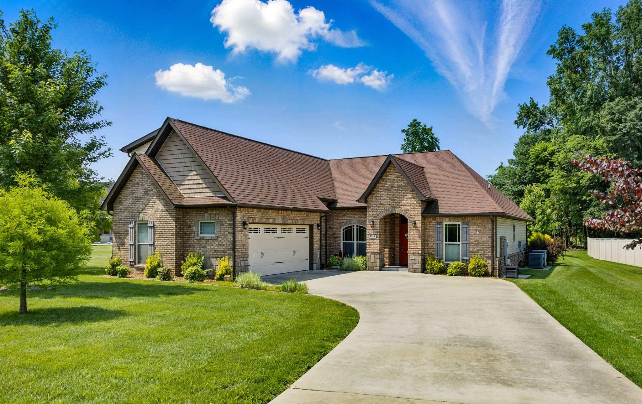 a front view of house with yard and green space