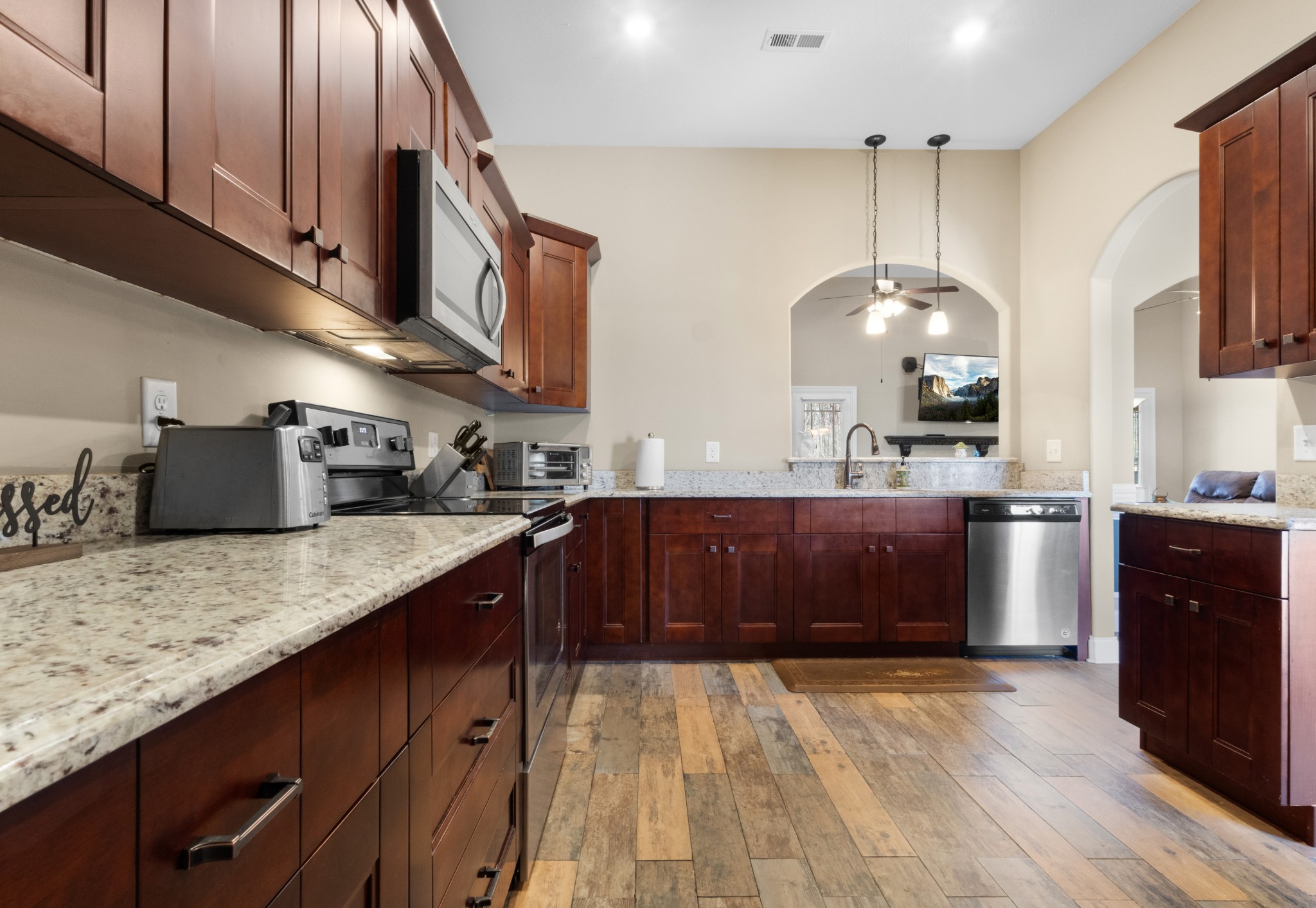4268 Sango Road Clarksville, TN 37043 - Photo 11 of 32 a kitchen with stainless steel appliances granite countertop a sink a stove and a wooden floors