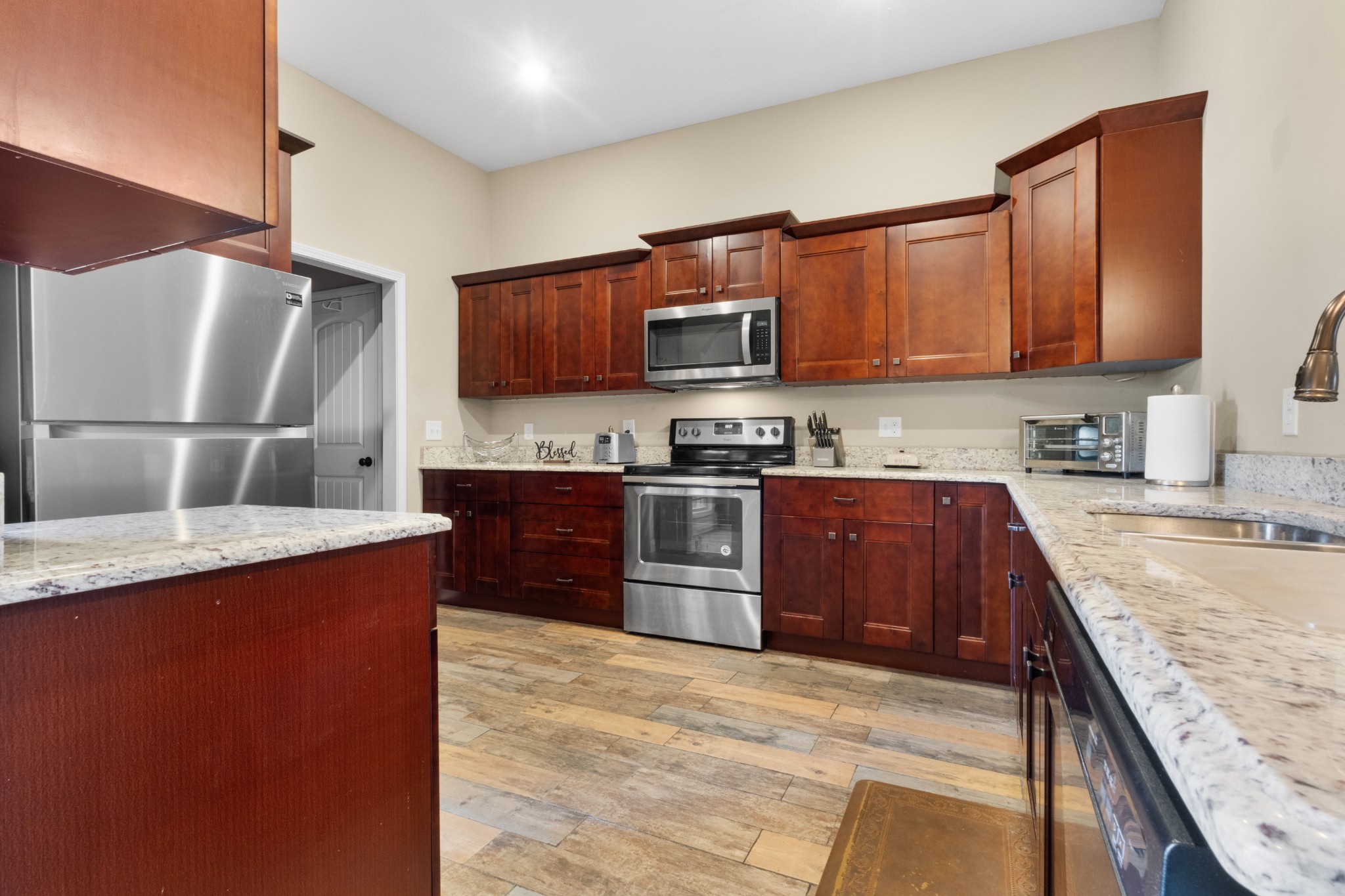 4268 Sango Road Clarksville, TN 37043 - Photo 12 of 32 a kitchen with stainless steel appliances granite countertop a refrigerator a stove top oven a sink and dishwasher