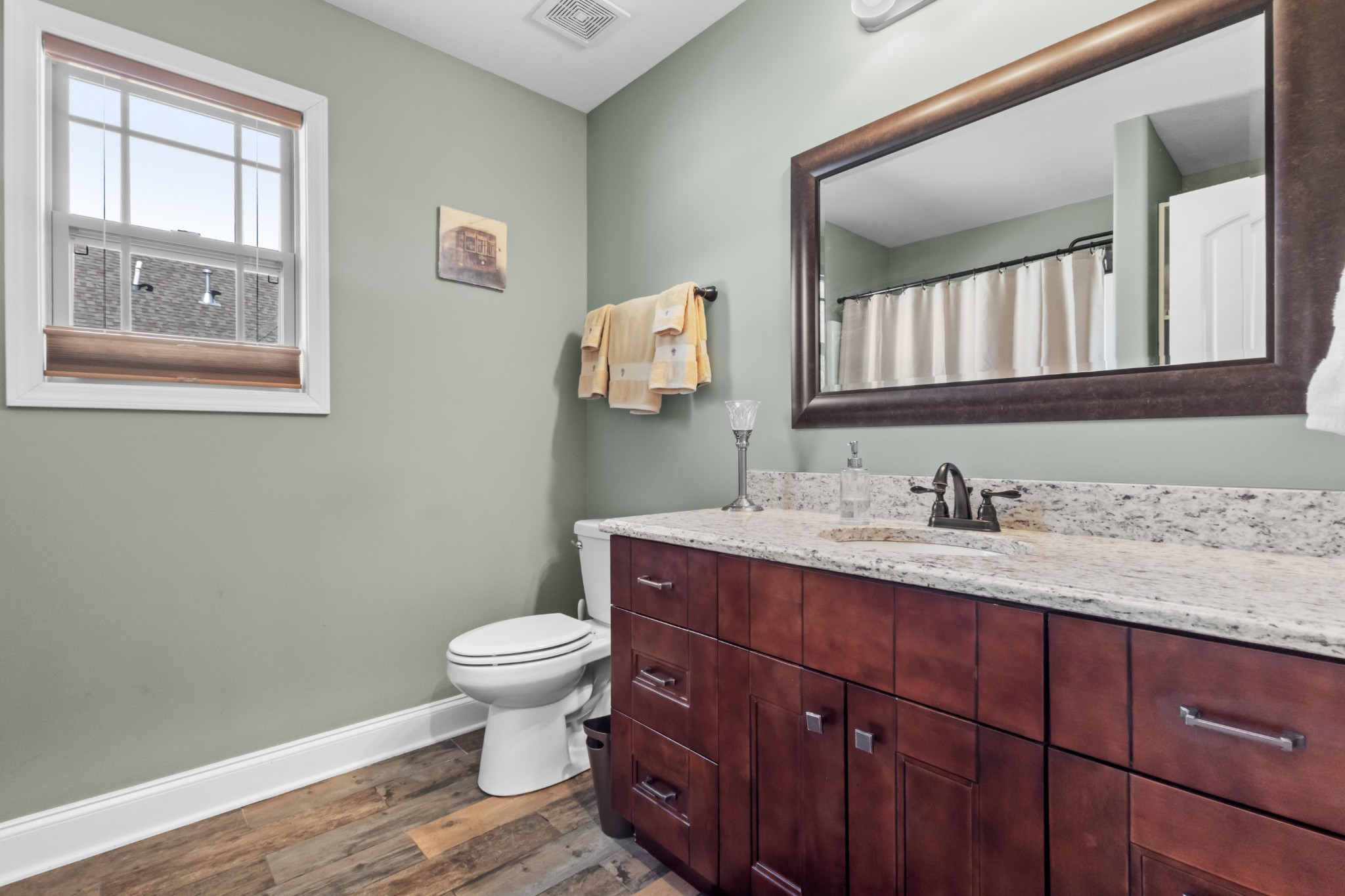 4268 Sango Road Clarksville, TN 37043 - Photo 19 of 32 a bathroom with a granite countertop toilet a sink and a mirror