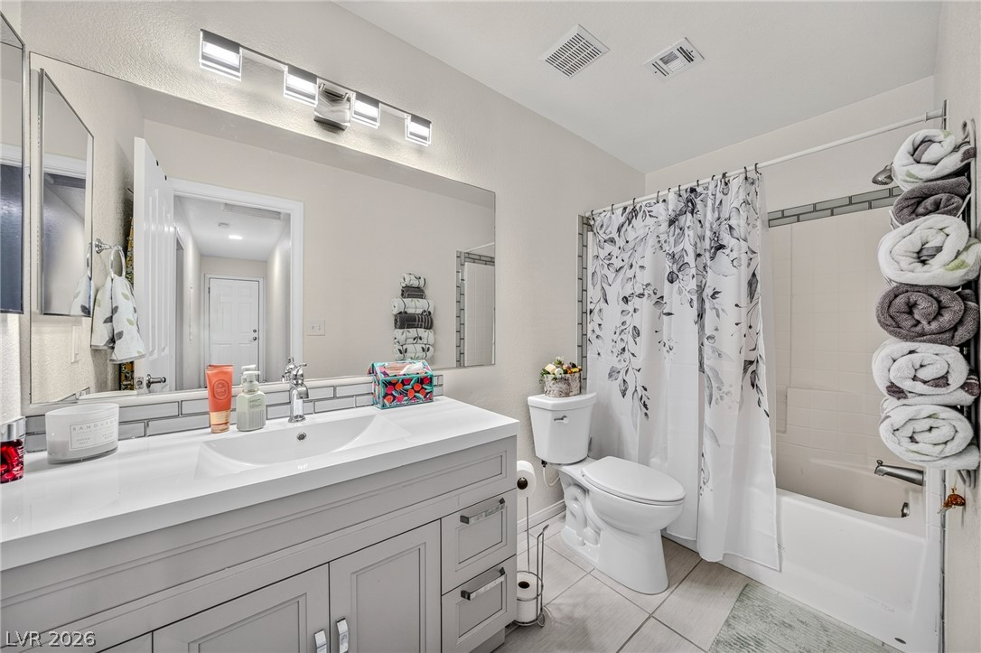 2970 Rio Rico Drive Pahrump, NV 89048 - Photo 18 of 41 Modern cabinetry and sleek tile accents create a polished aesthetic in this updated bathroom.