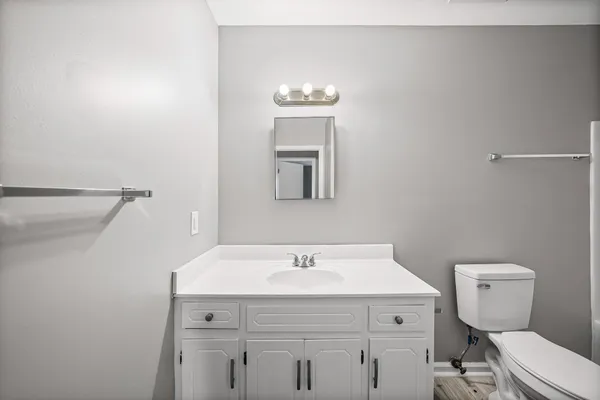 a bathroom with a sink mirror and toilet