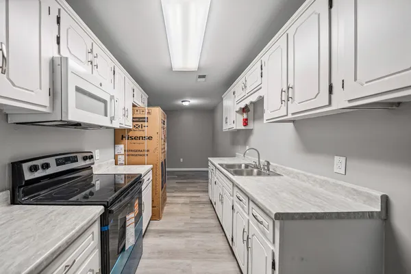 a kitchen with stainless steel appliances granite countertop a sink and a stove