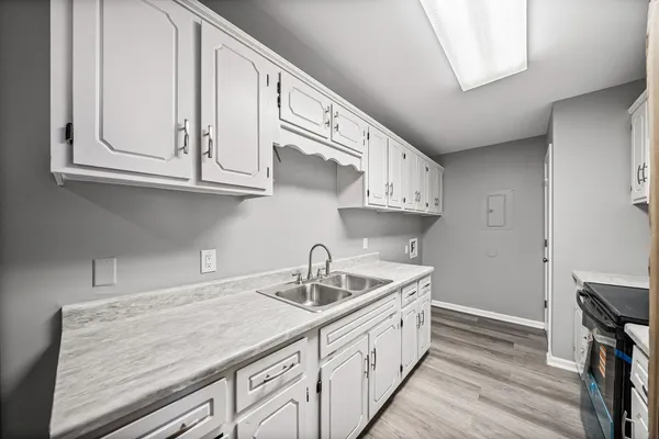 a kitchen with cabinets stainless steel appliances a sink and cabinets