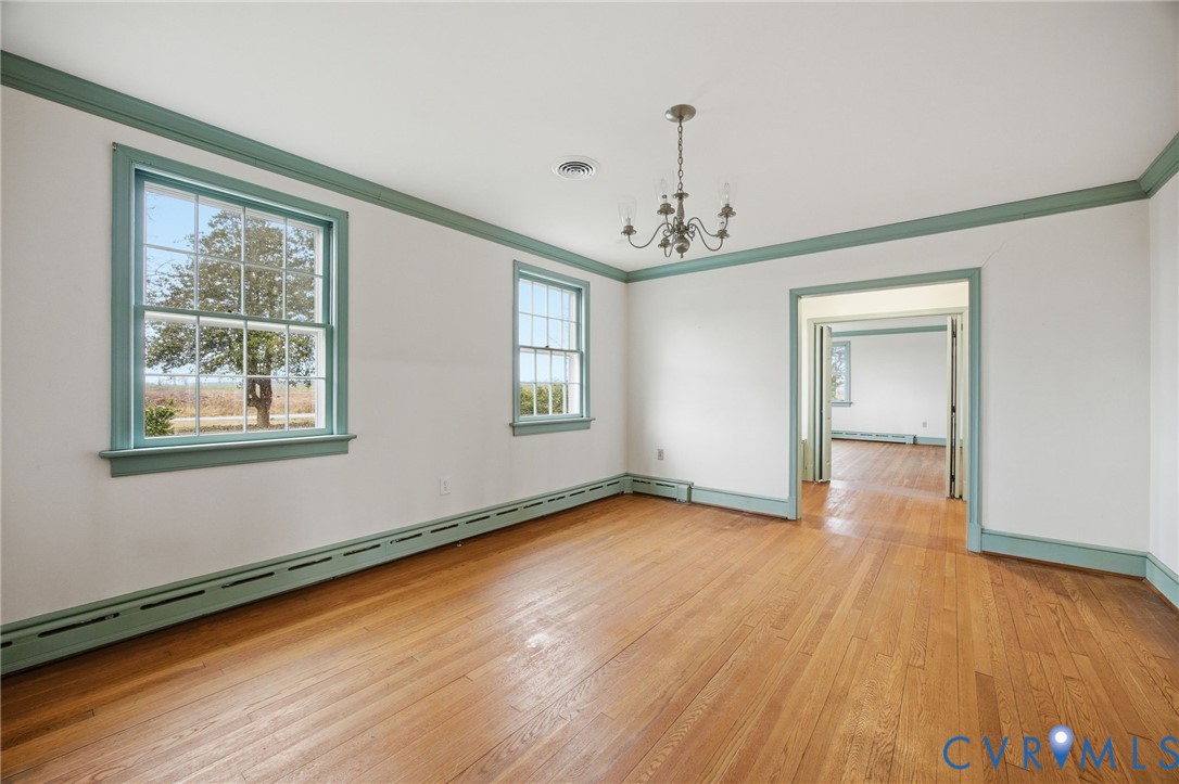6184 Henderson Road Stony Creek, VA 23882 - Photo 11 of 30 a view of an empty room with wooden floor and a window