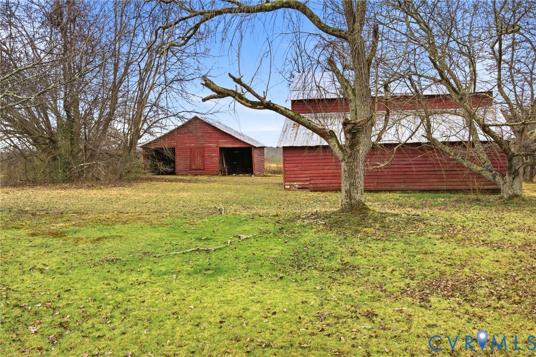 6184 Henderson Road Stony Creek, VA 23882 - Photo 15 of 30 a white house that has a tree in front of it