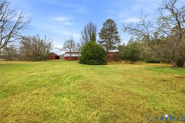 a view of yard with swimming pool and trees