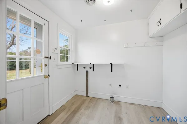 a view of a room with wooden floor and cabinet
