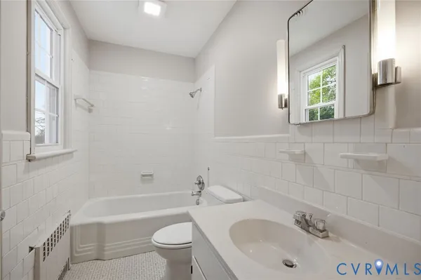 a bathroom with a sink a toilet and tub