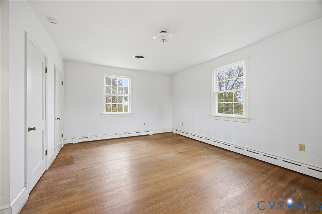 6184 Henderson Road Stony Creek, VA 23882 - Photo 28 of 30 an empty room with wooden floor and windows