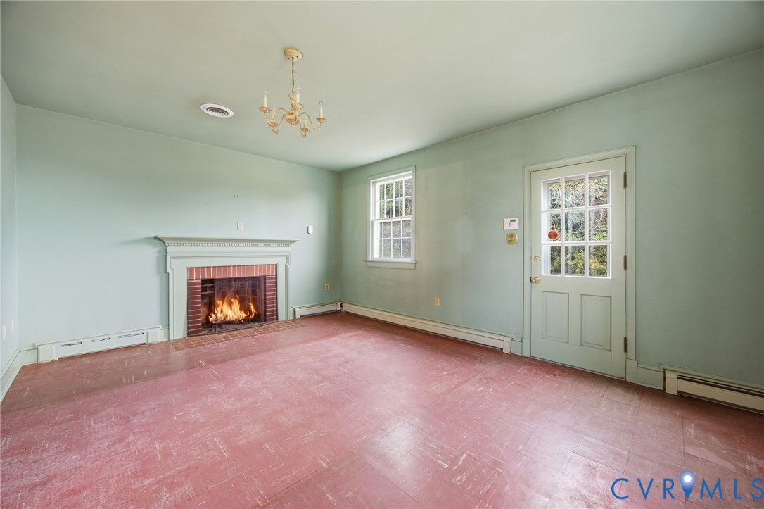 6184 Henderson Road Stony Creek, VA 23882 - Photo 29 of 30 an empty room with windows and fireplace