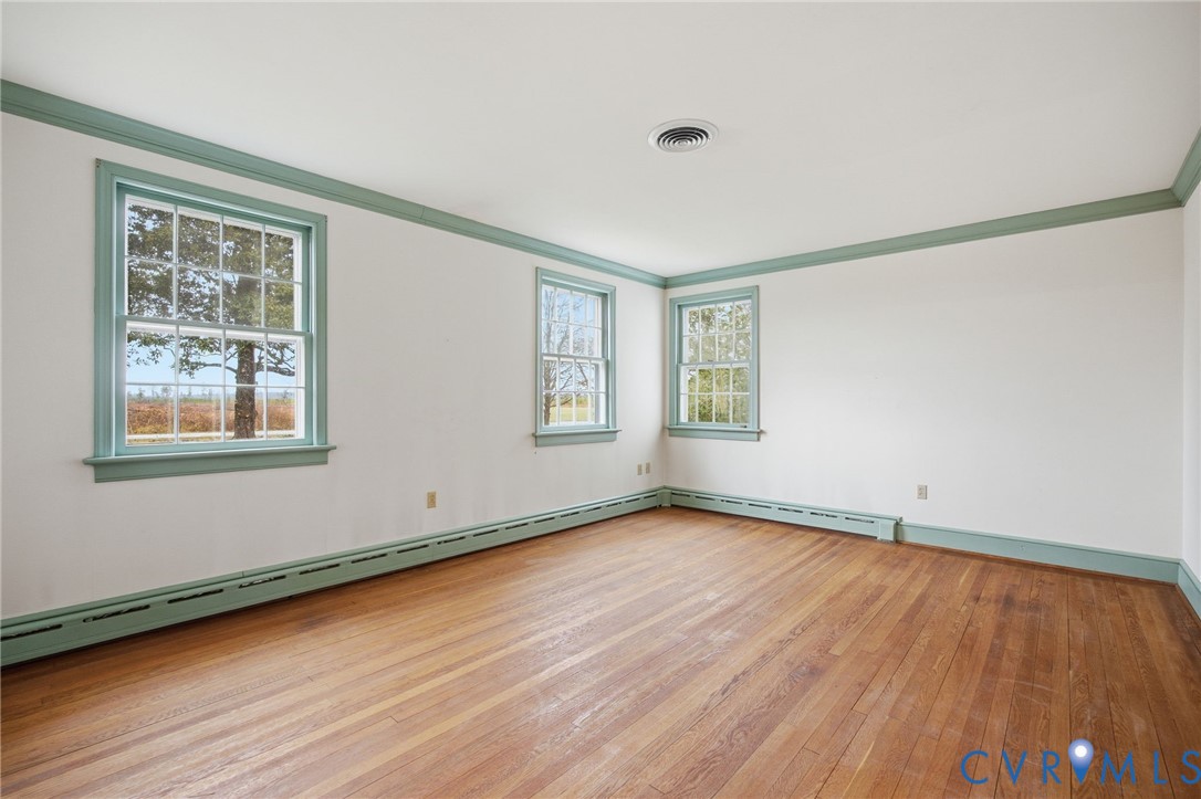 6184 Henderson Road Stony Creek, VA 23882 - Photo 7 of 30 a view of an empty room with wooden floor and a window