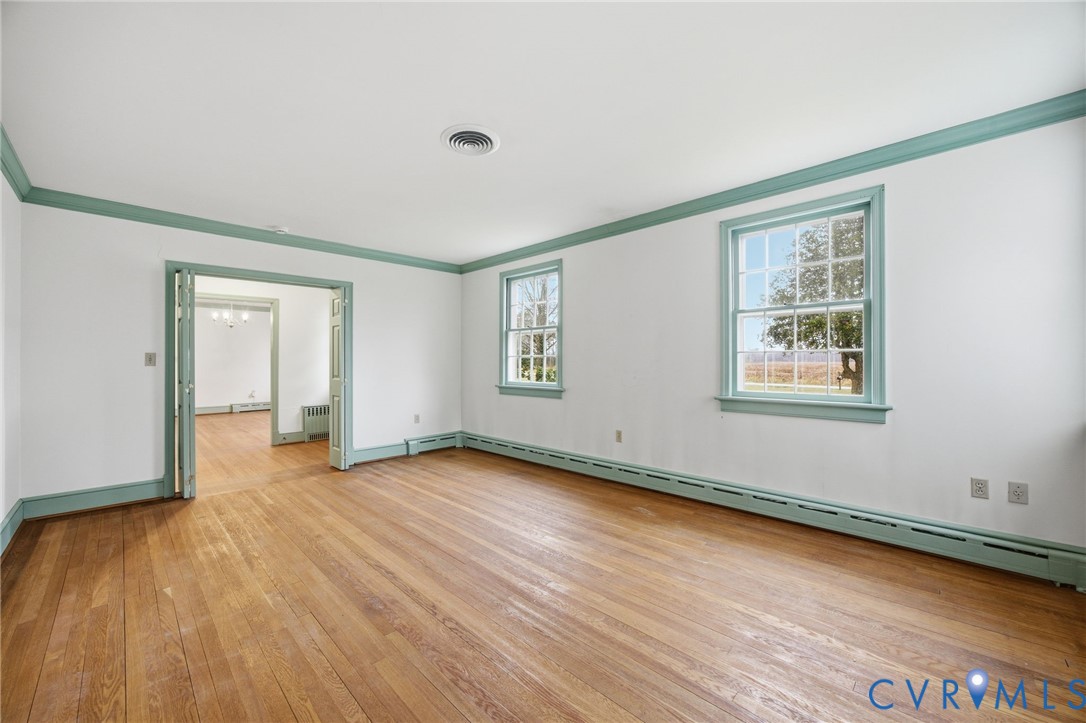 6184 Henderson Road Stony Creek, VA 23882 - Photo 9 of 30 a view of an empty room with wooden floor and a window