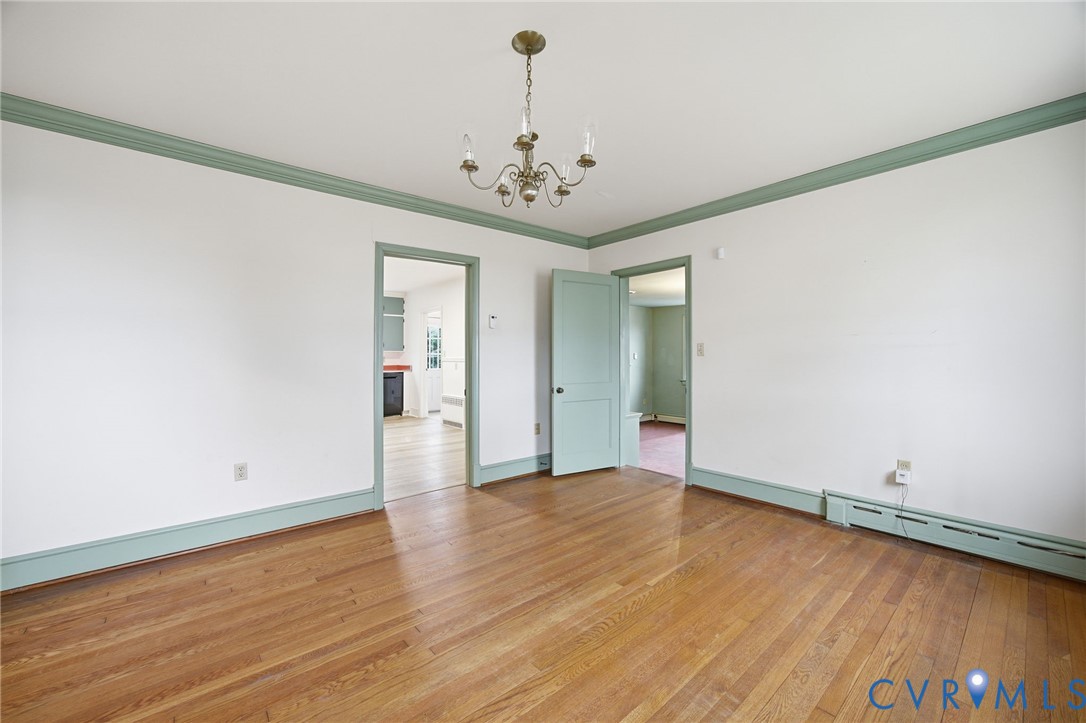 6184 Henderson Road Stony Creek, VA 23882 - Photo 10 of 30 wooden floor in an empty room with a window