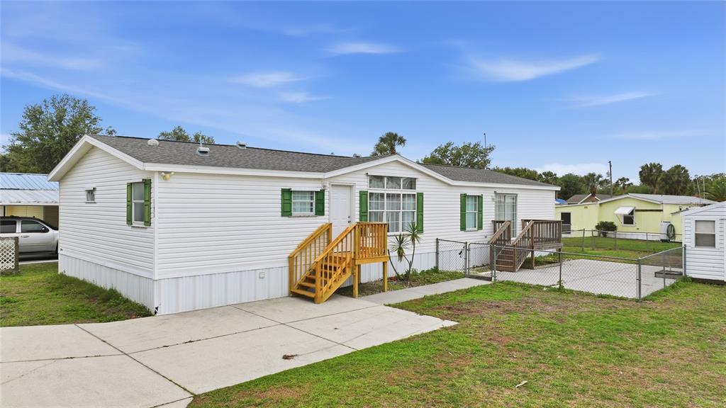 11923 Southwest Loop Terrace Arcadia, FL 34269 - Photo 1 of 50 a view of a white house with a patio and a yard