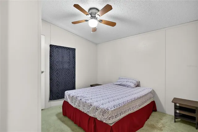 a bedroom with a bed and a mirror