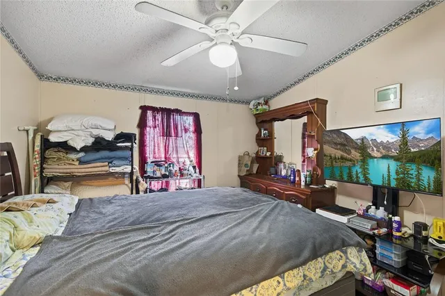 a bed room with a bed mirror and a flat screen tv