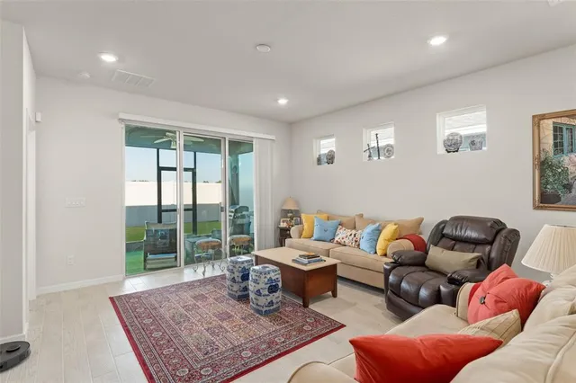 a living room with furniture rug and window