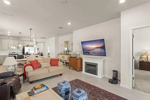 a living room with furniture a rug and a fireplace