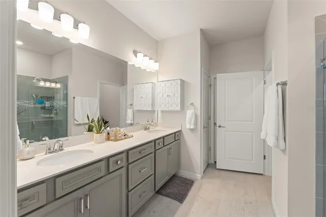 a spacious bathroom with a double vanity sink mirror and double
