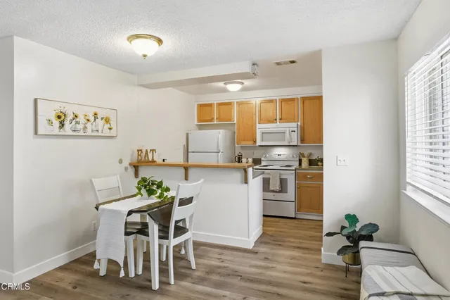 a kitchen with a refrigerator and a stove top oven
