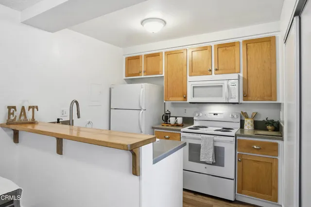 a kitchen with a stove a sink and a refrigerator