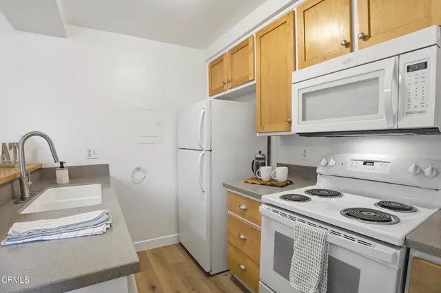 a kitchen with a stove cabinets and a refrigerator
