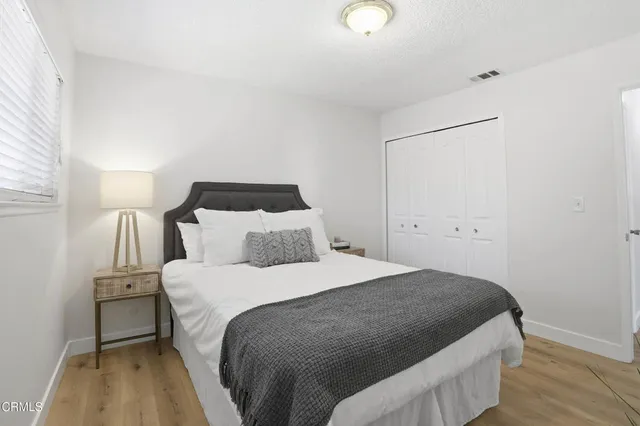 a bedroom with a bed and a night stand